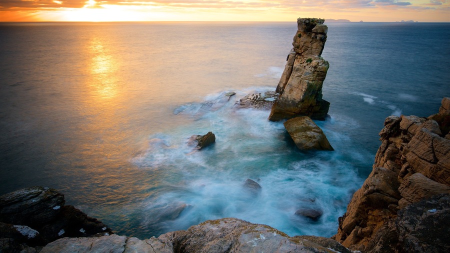 Cabo Carvoeiro showing general coastal views, a sunset and rocky coastline