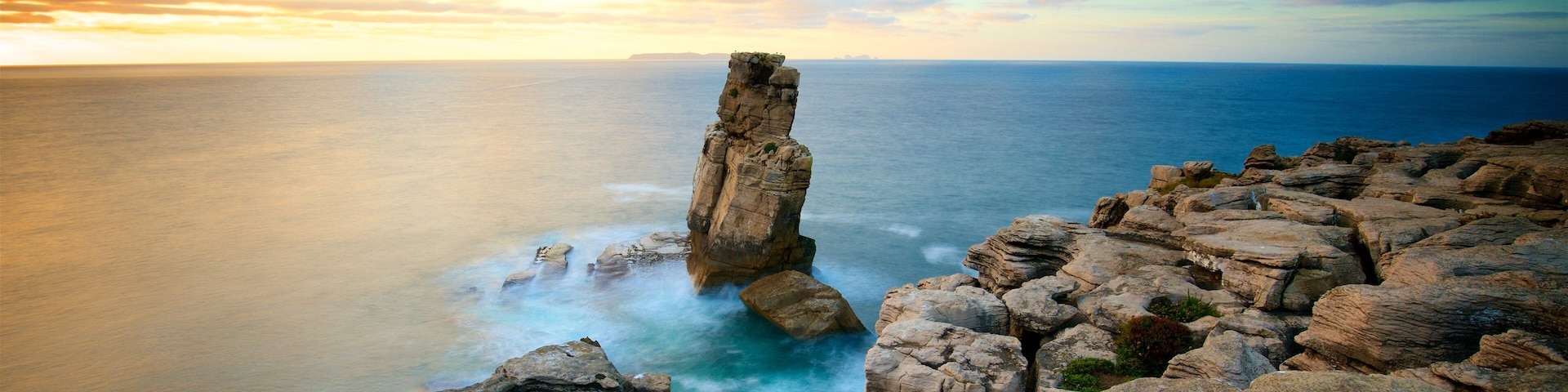 Cabo Carvoeiro which includes general coastal views, rugged coastline and a sunset