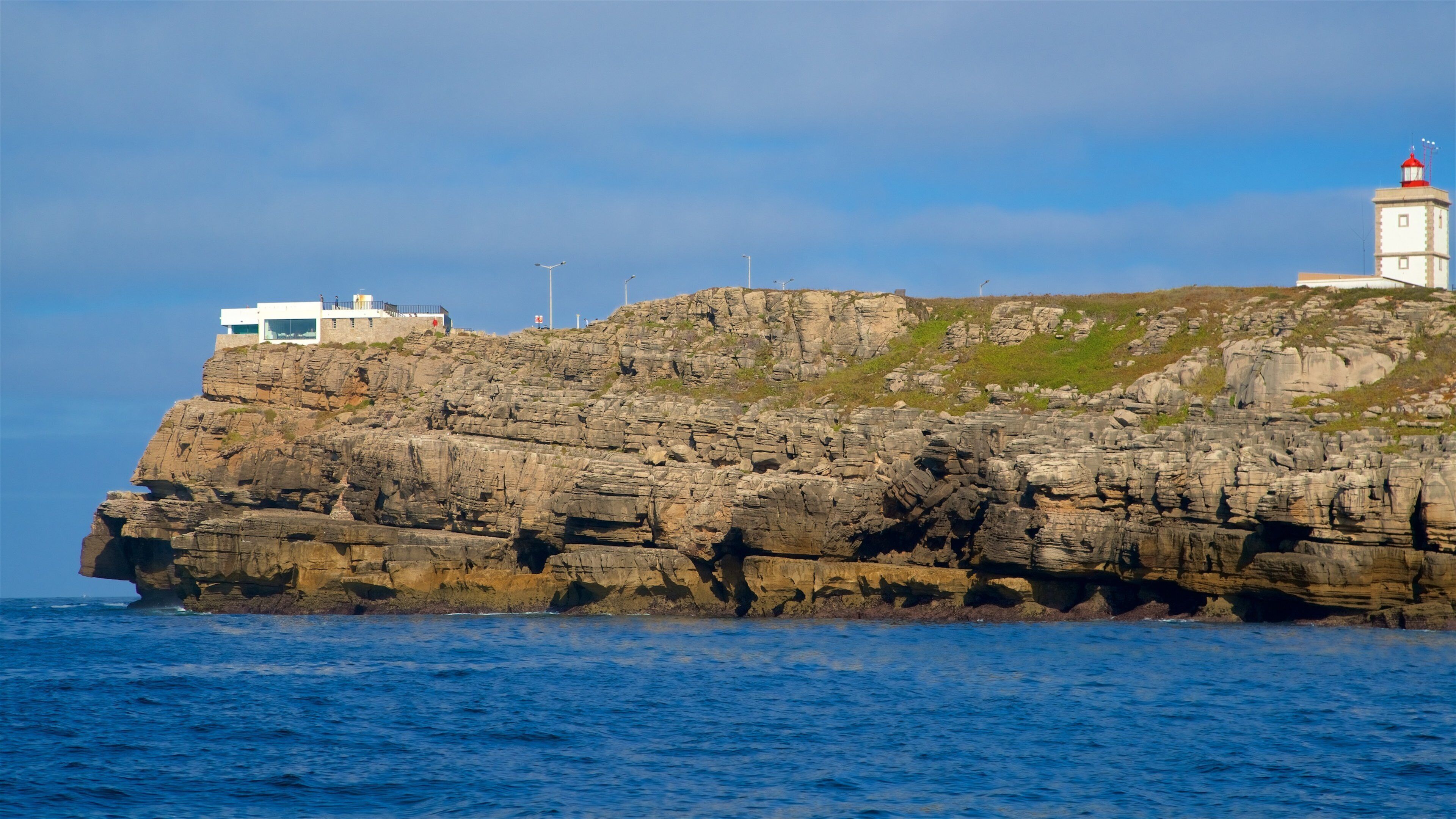Cabo Carvoeiro showing rugged coastline, general coastal views and a lighthouse