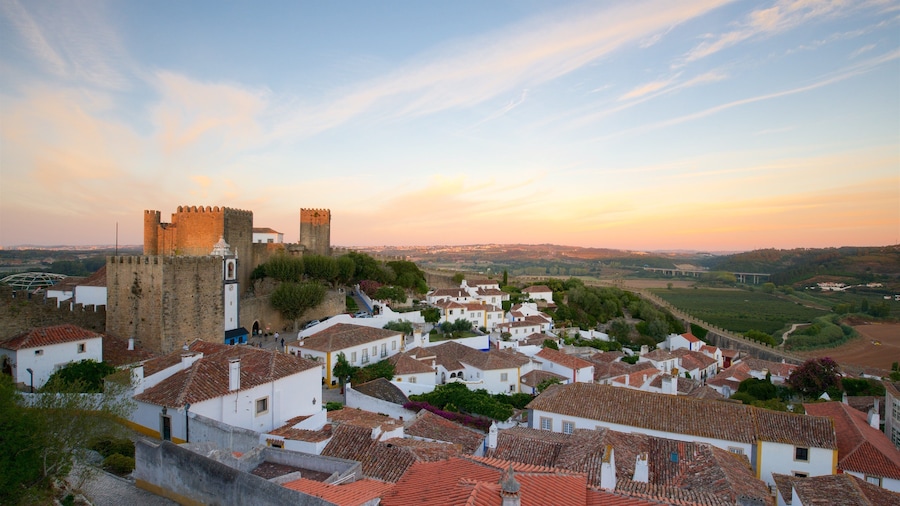 Obidos Castle which includes landscape views and a sunset
