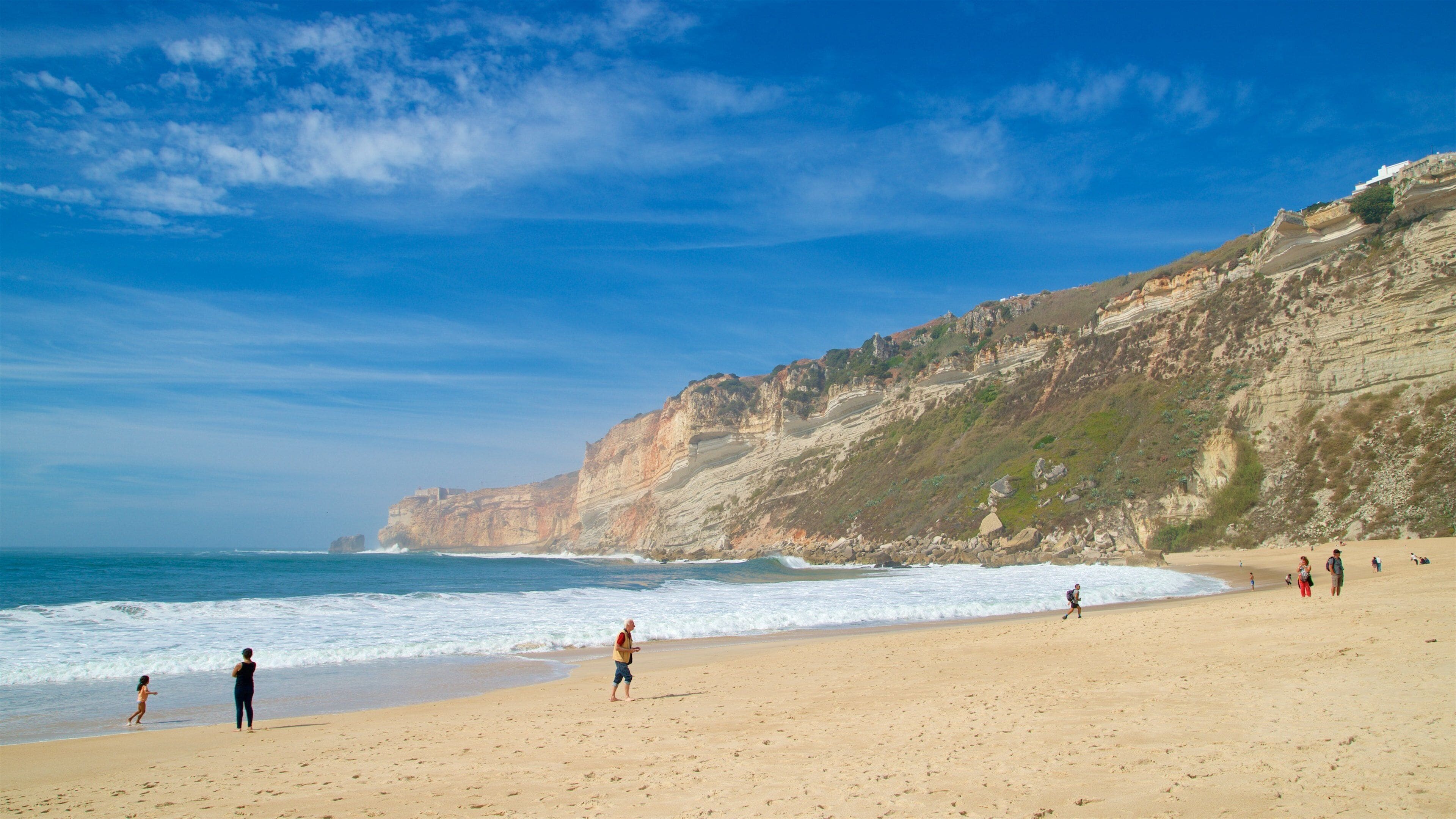 Nazare Beach which includes a beach, rugged coastline and general coastal views