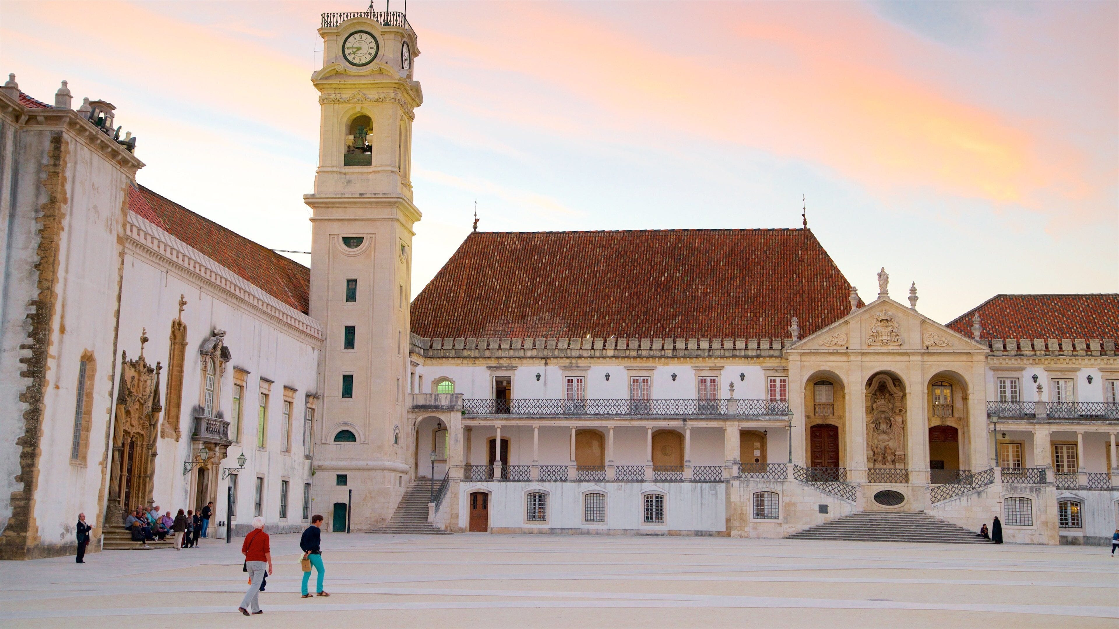 Coimbra University which includes heritage elements, a sunset and a square or plaza