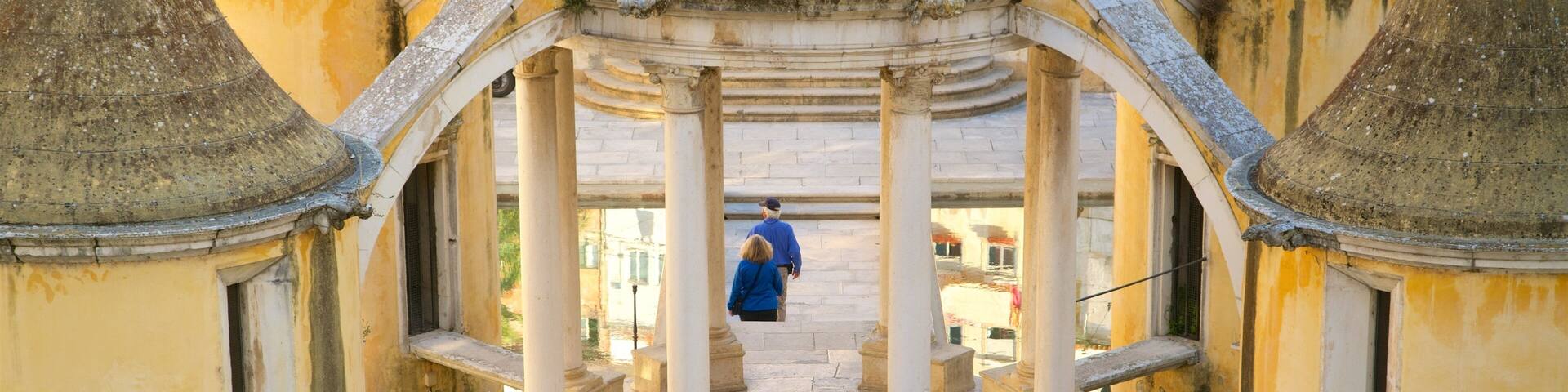 A historical building with a central courtyard, columns, and domed roofs.