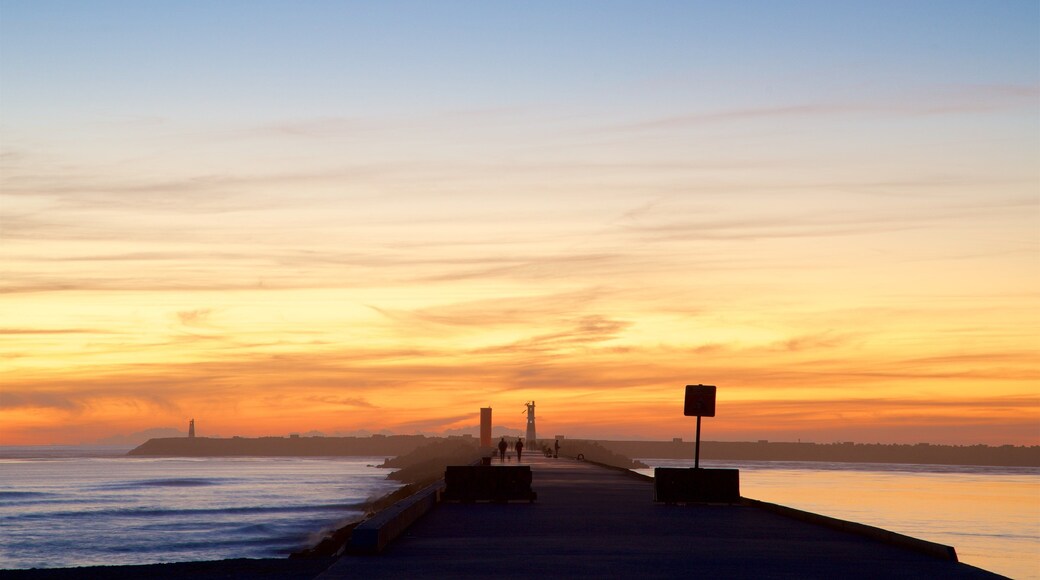 Barra Beach which includes a sunset and general coastal views