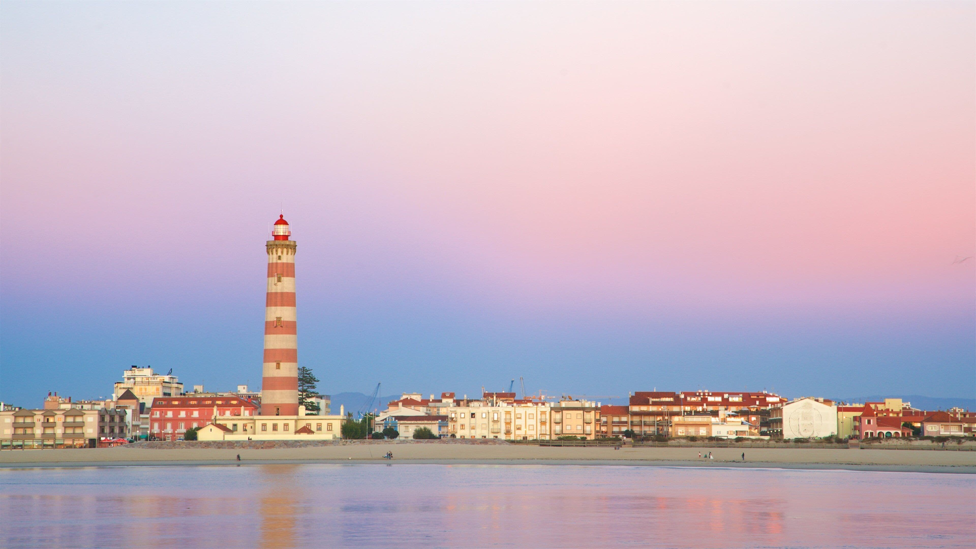 Barra Beach which includes a coastal town, general coastal views and a lighthouse