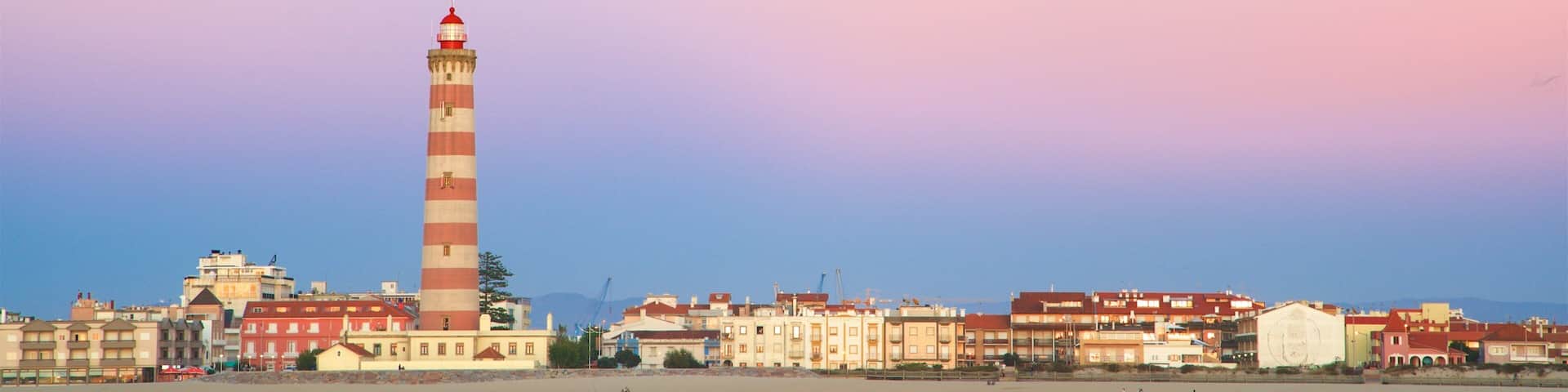 Barra Beach which includes a coastal town, general coastal views and a lighthouse