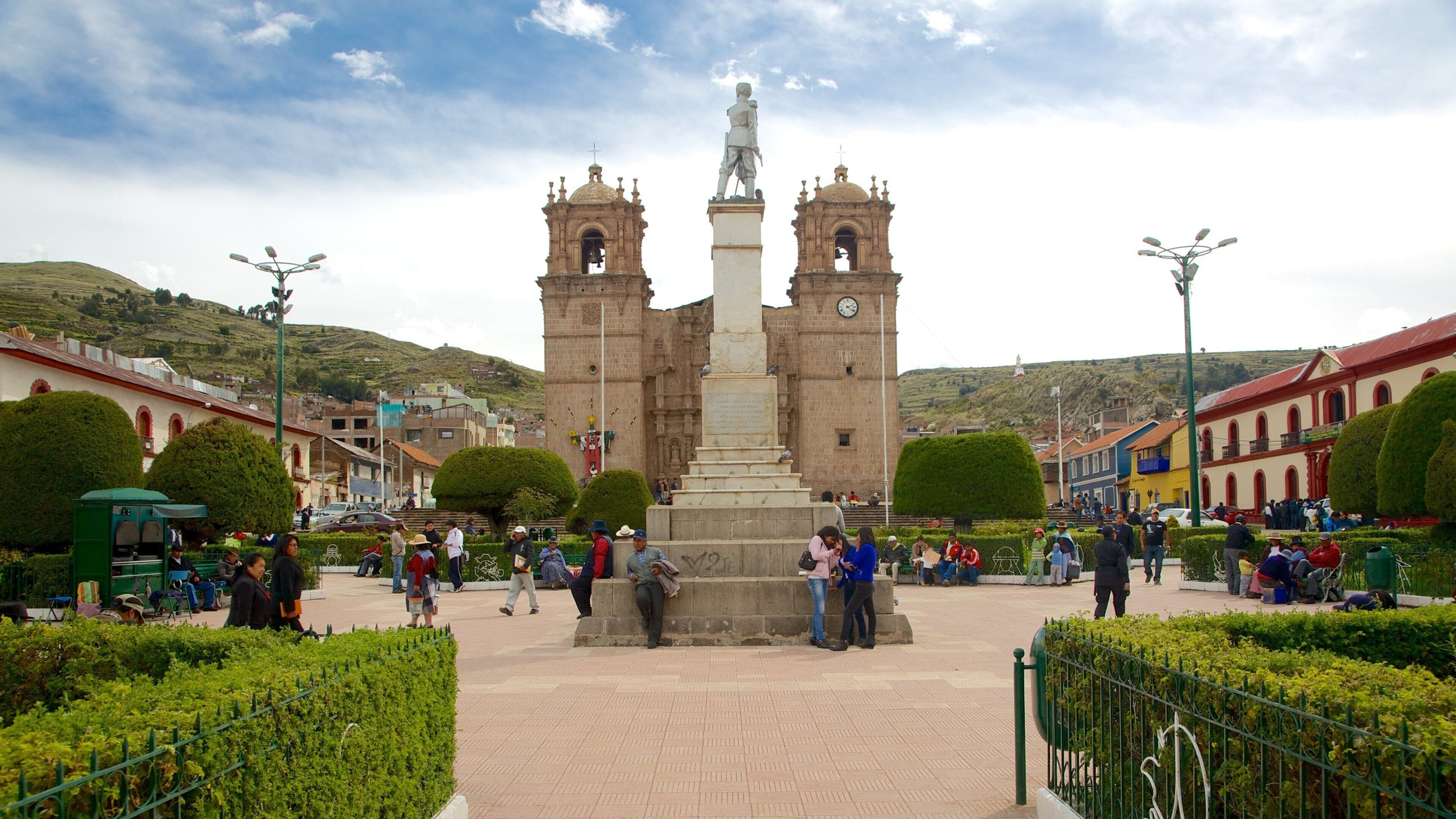 Puno Plaza de Armas which includes a statue or sculpture and heritage elements as well as a small group of people