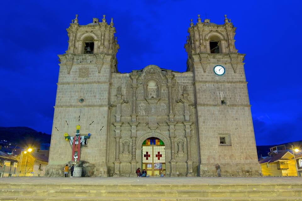A historic cathedral with two towers and a large clock.