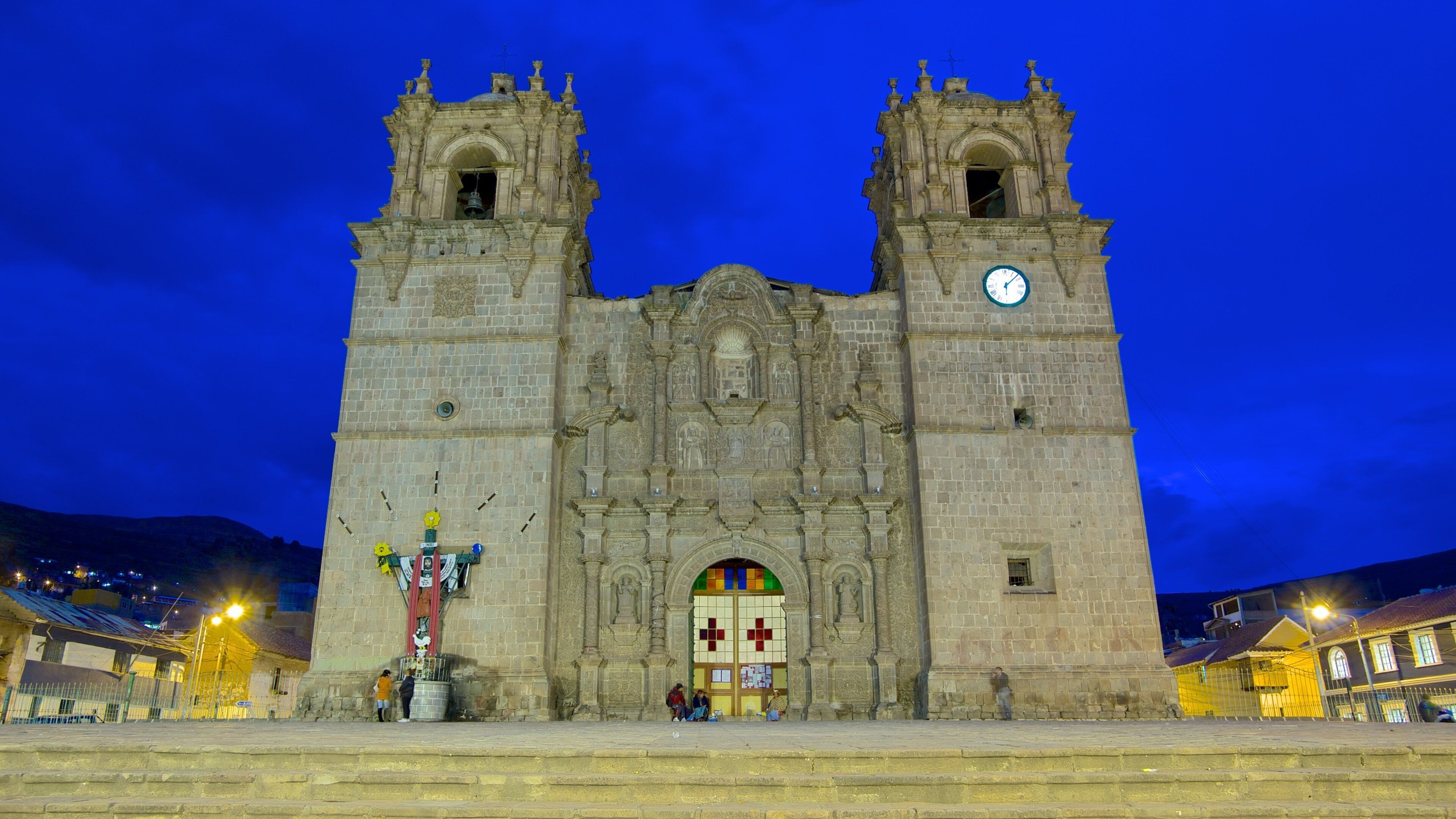 A historic cathedral with two towers and a large clock.