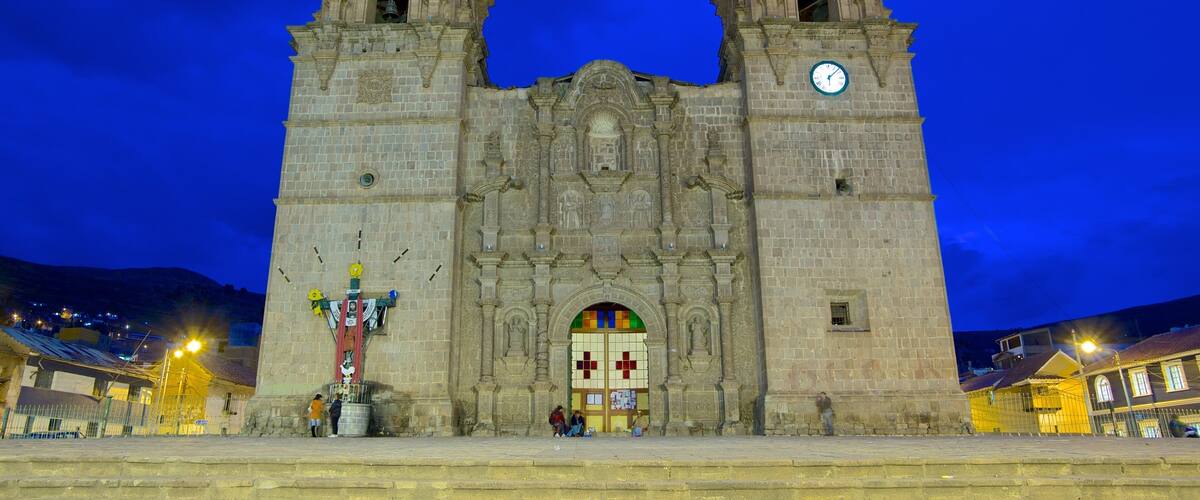 A historic cathedral with two towers and a large clock.
