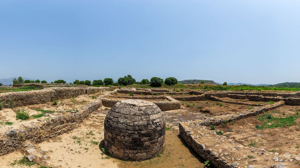Ancient stone ruins with circular structures and pathways.