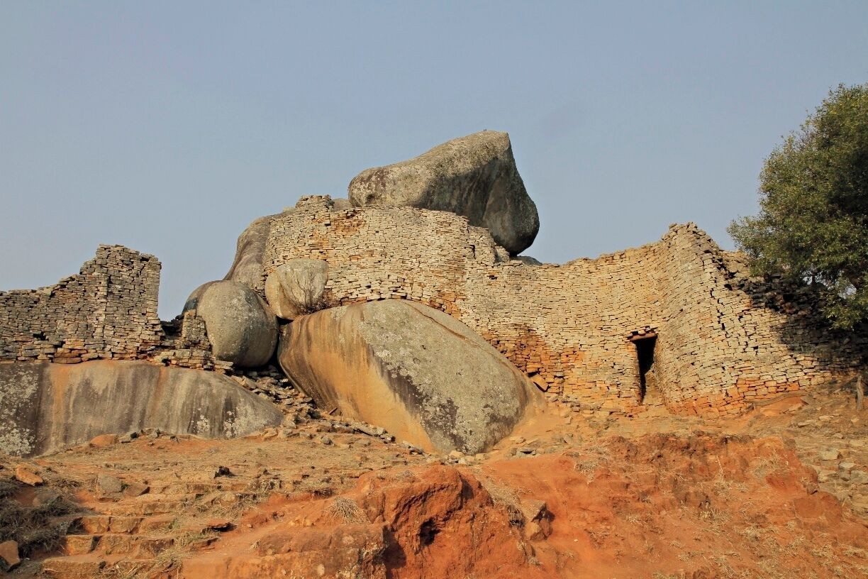 Ancient ruins with large stone blocks and brick structures.