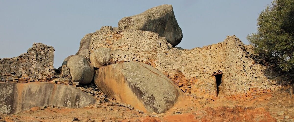 Ancient ruins with large stone blocks and brick structures.