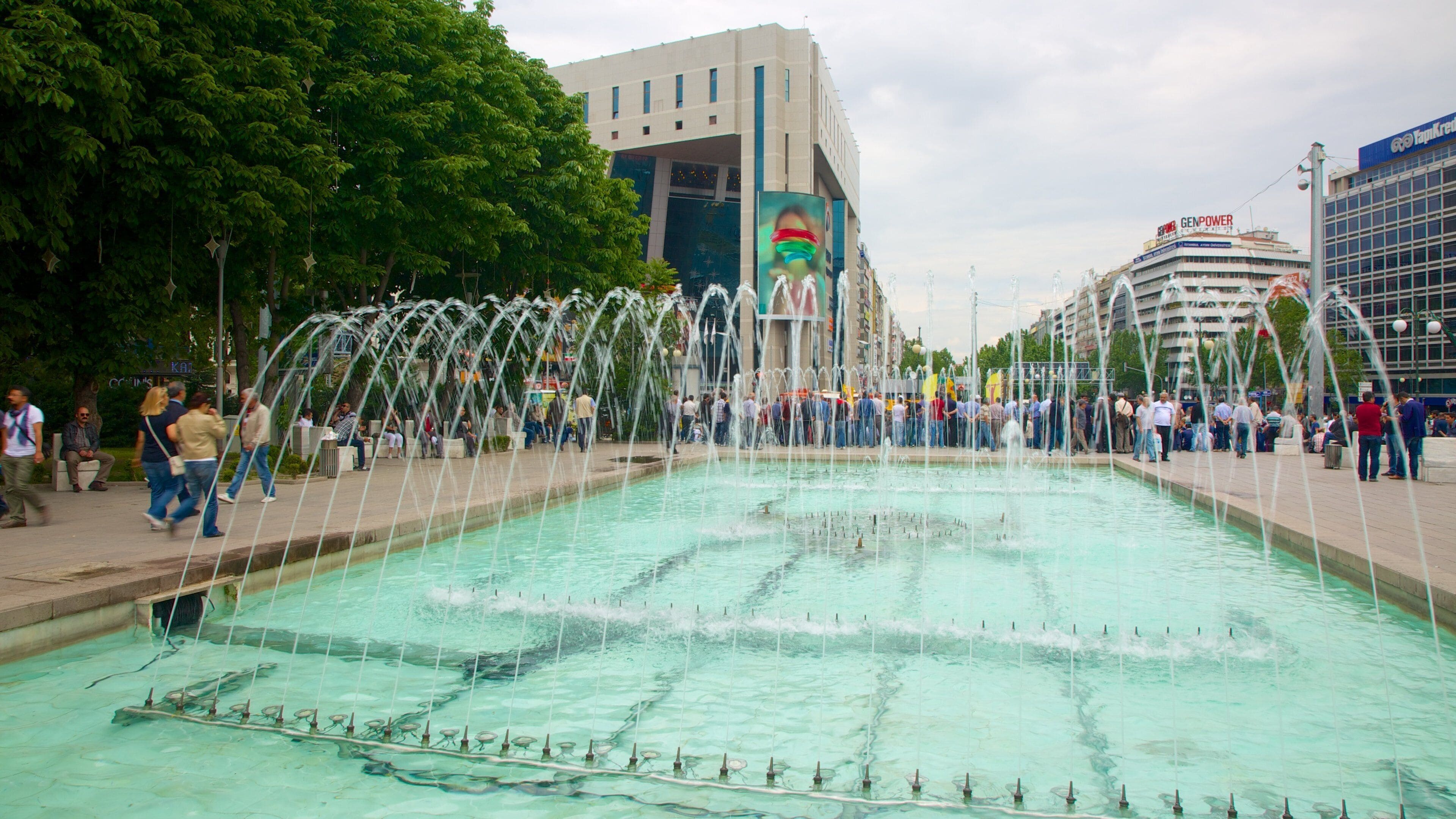 Kizilay Square showing a fountain as well as a large group of people