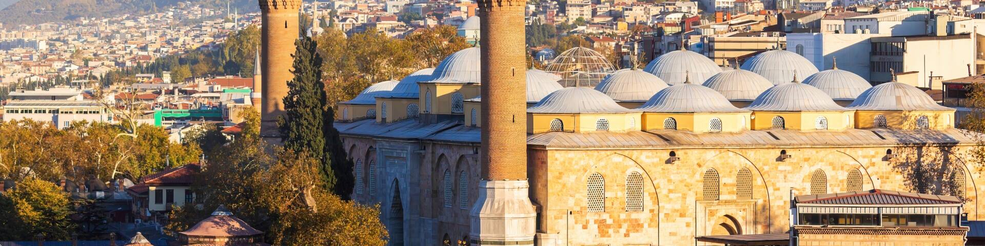 View of Bursa Grand Mosque/Ulu Cami from the hill. Cityscape and the slope of Uludag mountain at background. Bursa,Turkey.