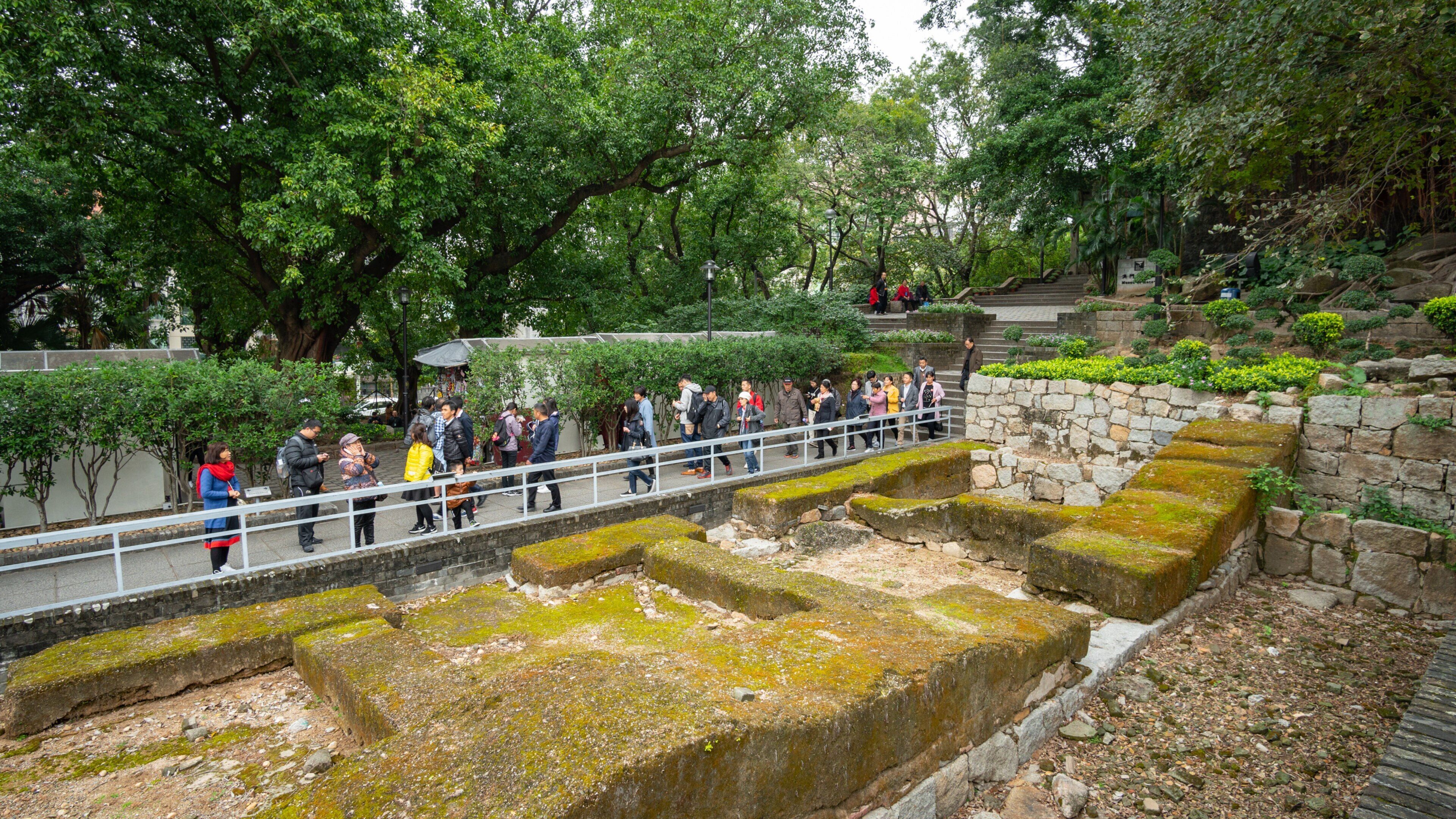 Ruins of St. Paul\'s Cathedral which includes a garden and building ruins as well as a small group of people