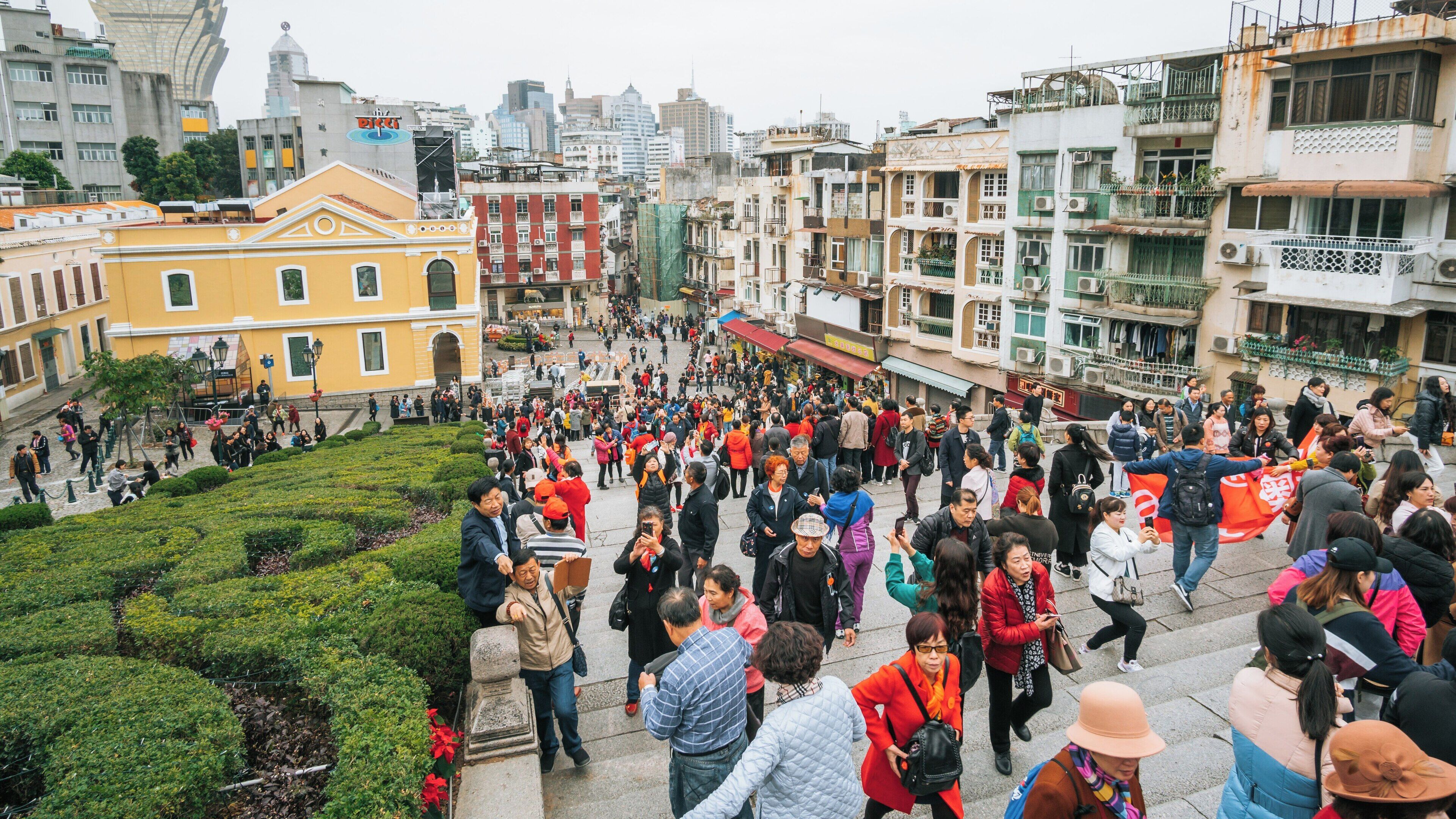 Ruins of St. Paul's Cathedral draws visitors in bustling Macau, showcasing cultural heritage and historical significance