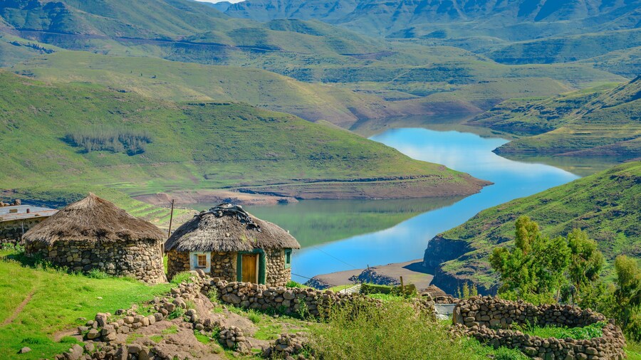 Lesotho traditional hut house homes in Lesotho village in Africa. Beautiful scenic landscape of village in daytime with typical huts built by villagers by the lake of Mohale Dam