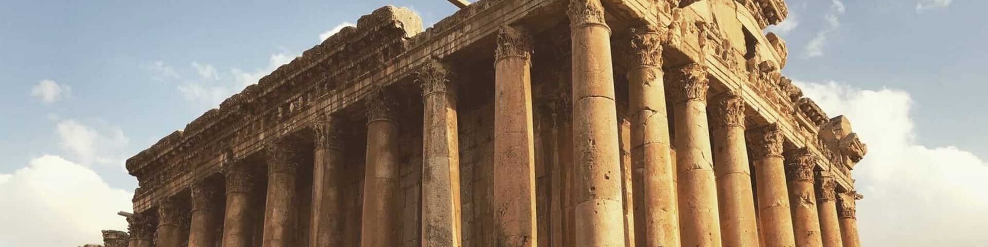 An ancient temple with tall columns and intricate carvings.