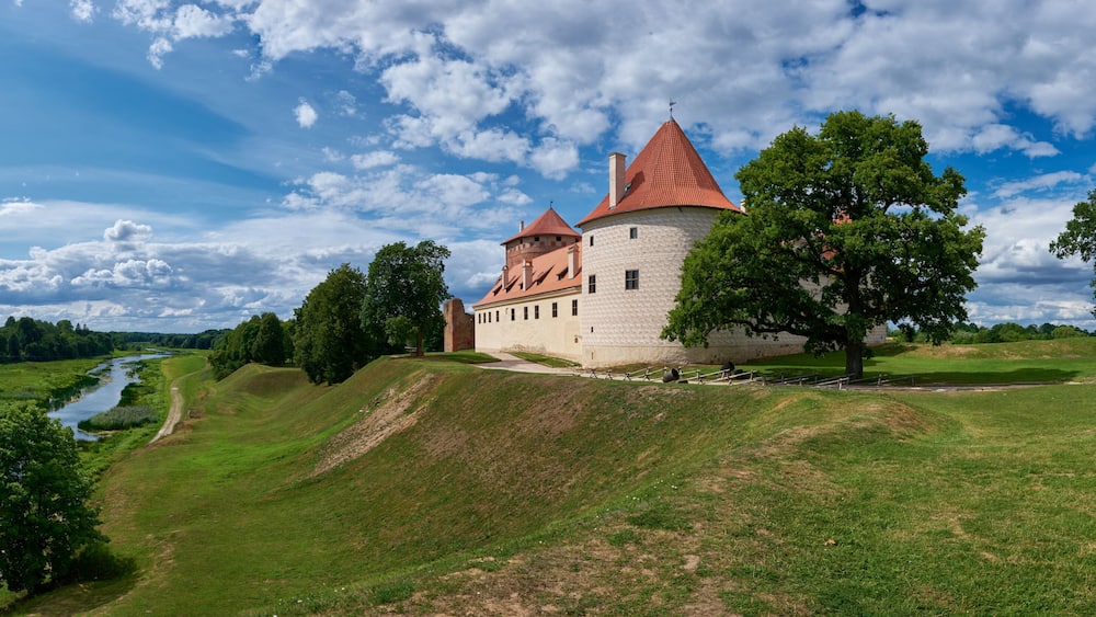 Panoranic view of latvian tourist landmark attraction - ruins of medieval Bauska castle and the remains of a later palace, located between the Memel and Musa rivers. Bauska, Latvia.