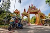 Tuk tuk motorbike taxi in Wat Si Muang Buddhist temple in Vientiane, Laos