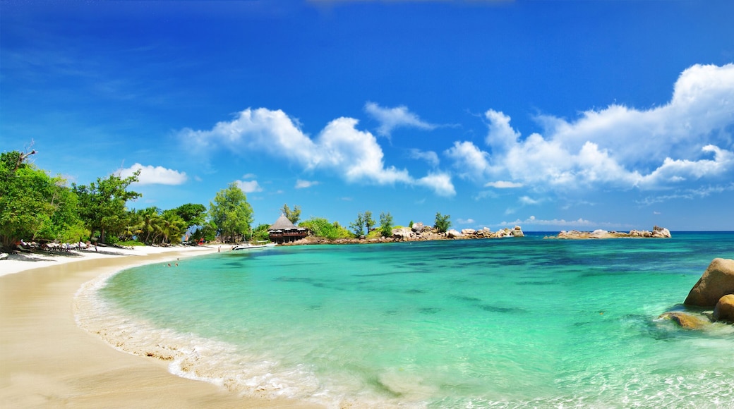 Panoramic view of Anse Georgette beach at Constance Lemuria Resort, Praslin, Seychelles. Tropical bay with granite rocks and turquoise ocean water.