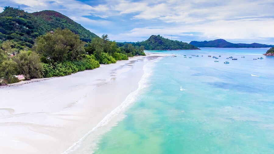 Aerial view of white sand and turquoise water in Anse Volbert beach
