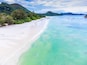 Aerial view of white sand and turquoise water in Anse Volbert beach