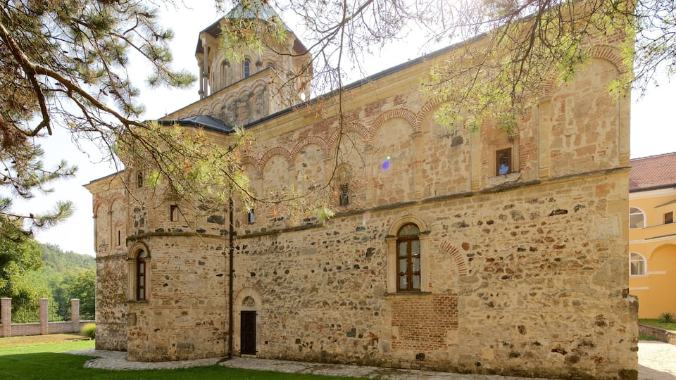 A historic stone building with arched windows and a bell tower.