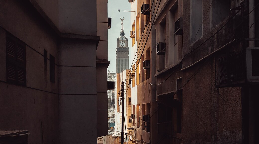 Rich versus Poor. The World's 3rd tallest building, Makkah Clock Tower of the Abraj Al-Bait towers is seen through the street of an old abandoned neighborhood atop a mountain, in Makkah, Saudi Arabia.