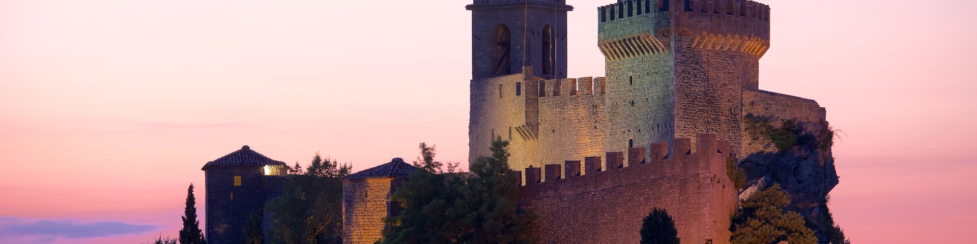 Torre Guaita que inclui um pequeno castelo ou palácio, um pôr do sol e elementos de patrimônio