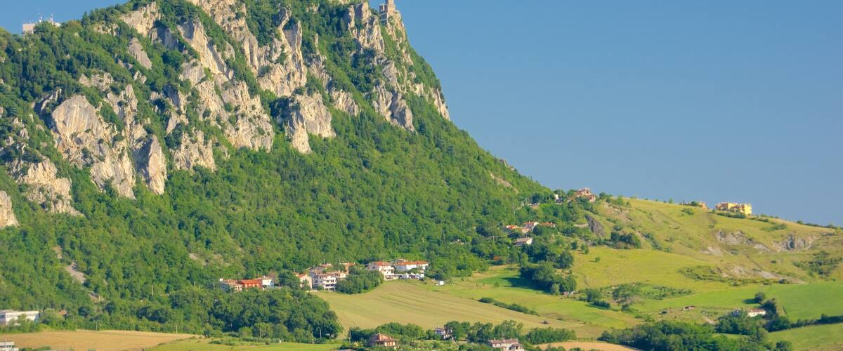 Monte Titano which includes tranquil scenes, a small town or village and mountains