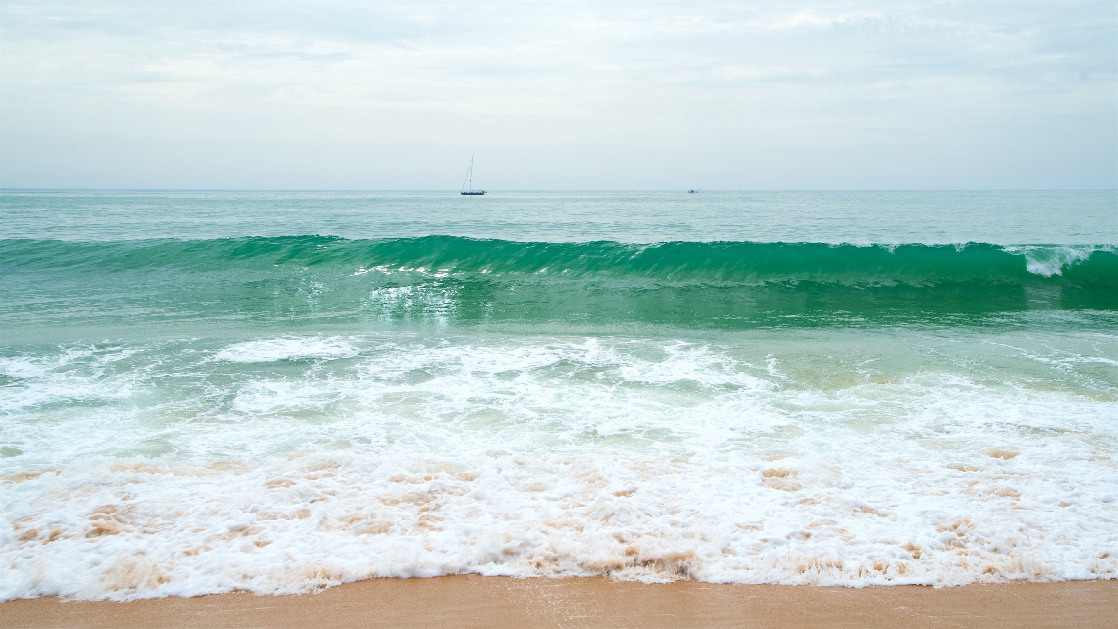 Marina Beach which includes general coastal views, a beach and waves