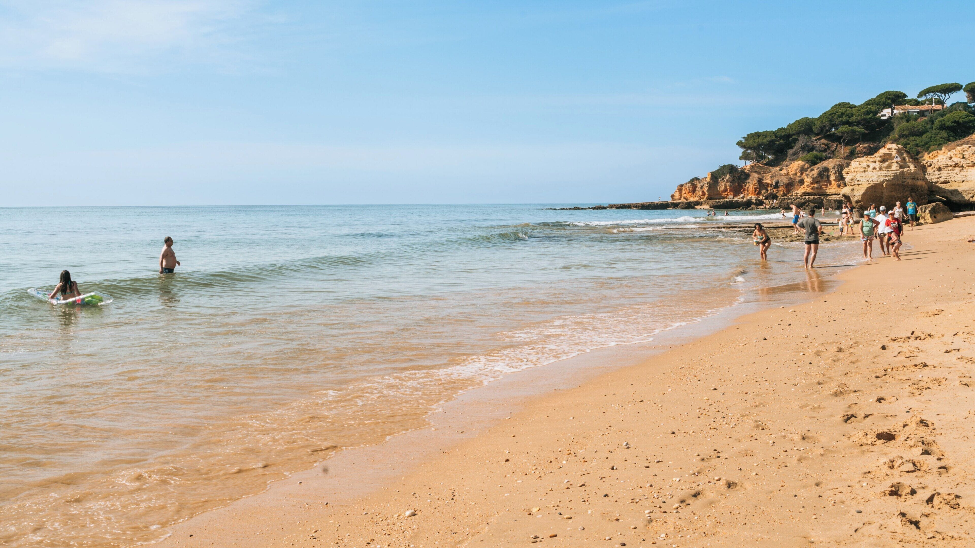 Sao Rafael Beach in Albufeira attracts visitors enjoying sun, sand, and sea in the Faro District of Portugal on a clear day