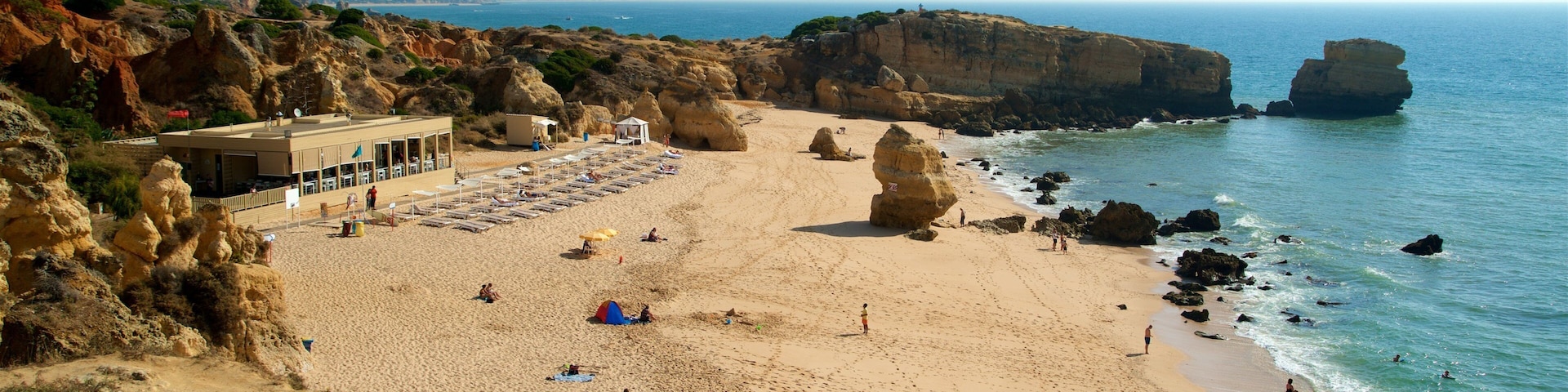 Coelha Beach which includes general coastal views, a beach and rugged coastline
