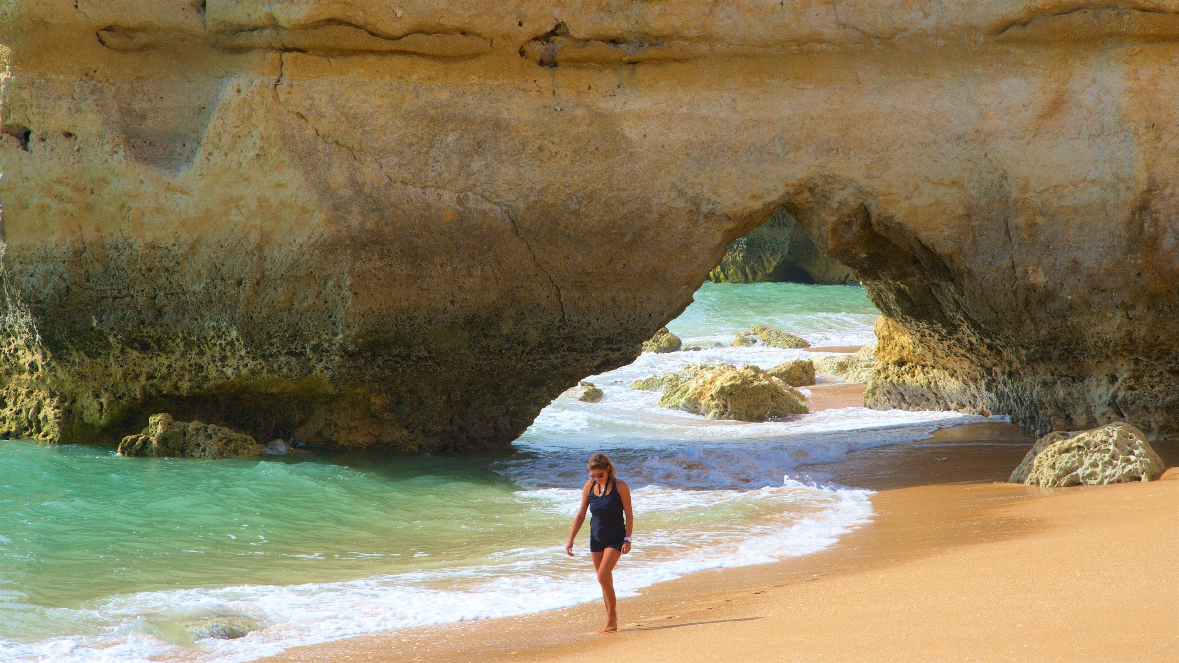 Coelha Beach which includes general coastal views, a beach and rugged coastline