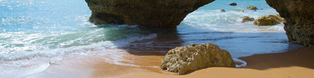 Coelha Beach showing rugged coastline, general coastal views and a beach