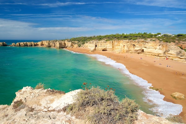 Coelha Beach featuring general coastal views, rocky coastline and a sandy beach