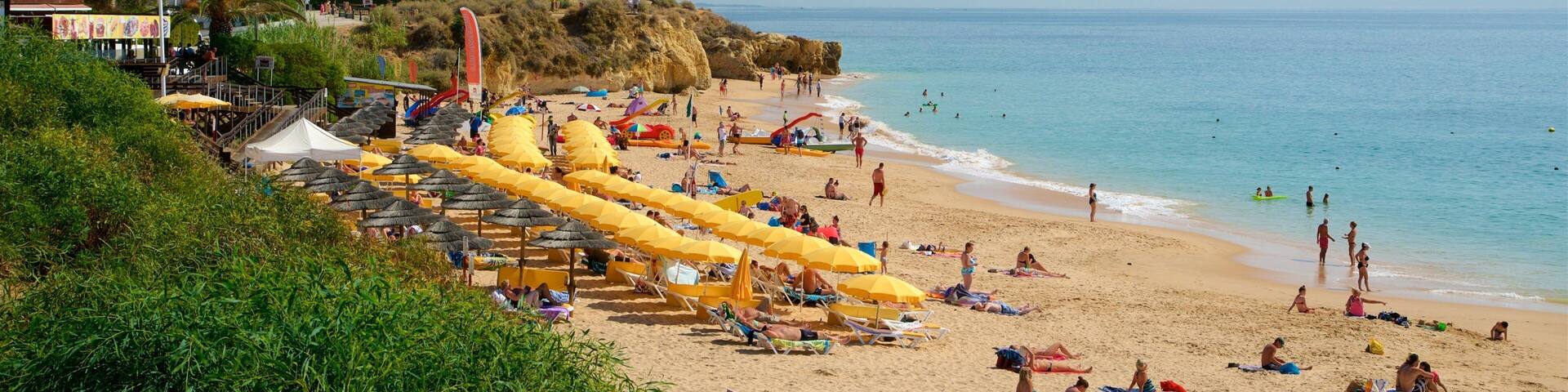 Oura Beach which includes a beach, a coastal town and general coastal views