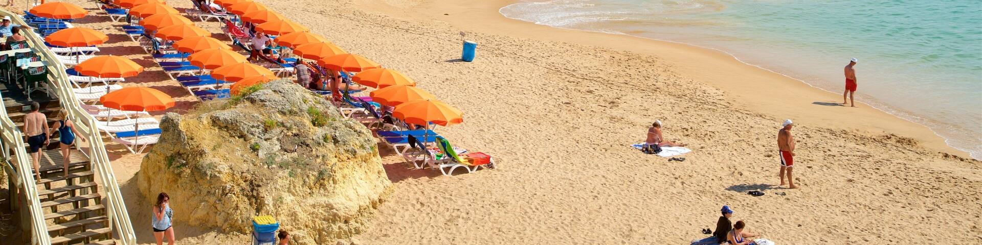 Oura Beach showing a sandy beach, general coastal views and swimming