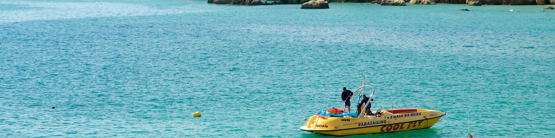 Oura Beach featuring boating, rugged coastline and general coastal views