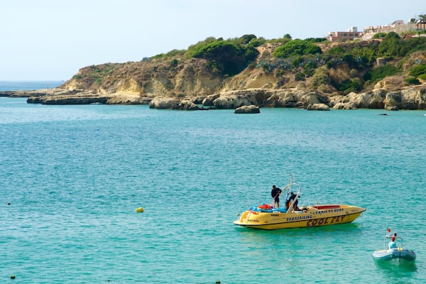 Oura Beach featuring rugged coastline, boating and general coastal views