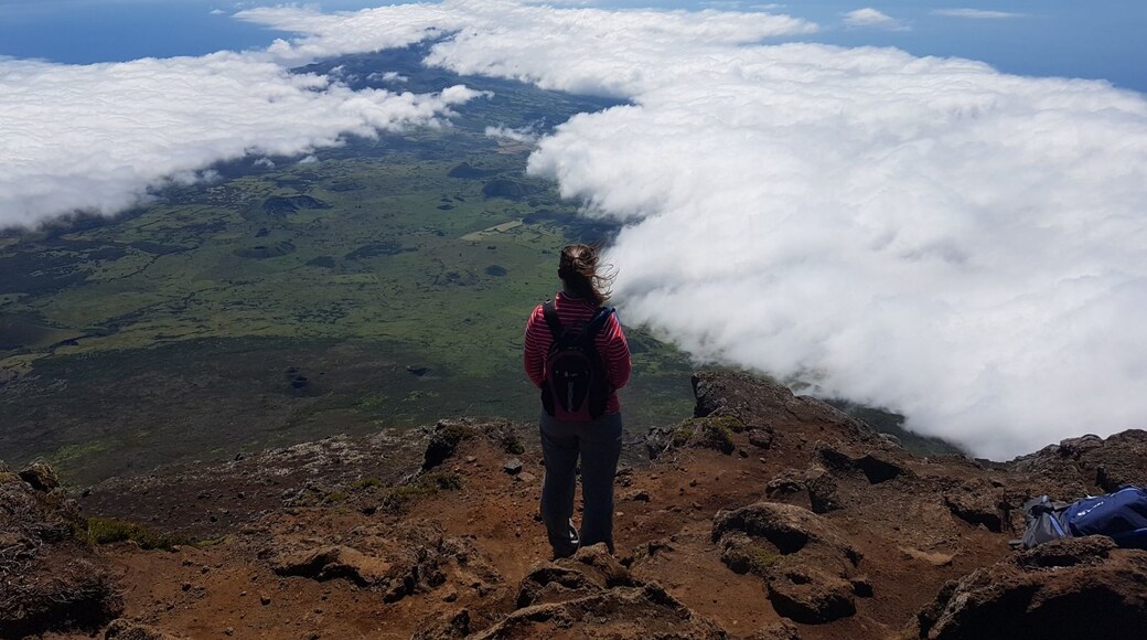 Hiking through hardened lava flow to reach the peak of the volcano. Feeling the warmth from the volcano and getting views like you're on top of the world!