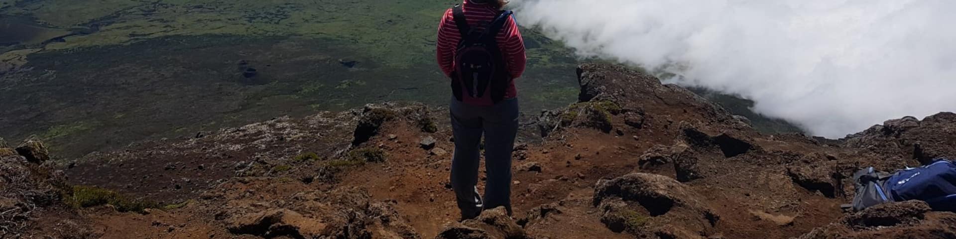 Hiking through hardened lava flow to reach the peak of the volcano. Feeling the warmth from the volcano and getting views like you're on top of the world!