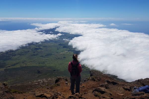 Hiking through hardened lava flow to reach the peak of the volcano. Feeling the warmth from the volcano and getting views like you're on top of the world!