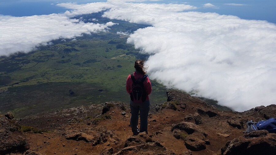 Hiking through hardened lava flow to reach the peak of the volcano. Feeling the warmth from the volcano and getting views like you're on top of the world!