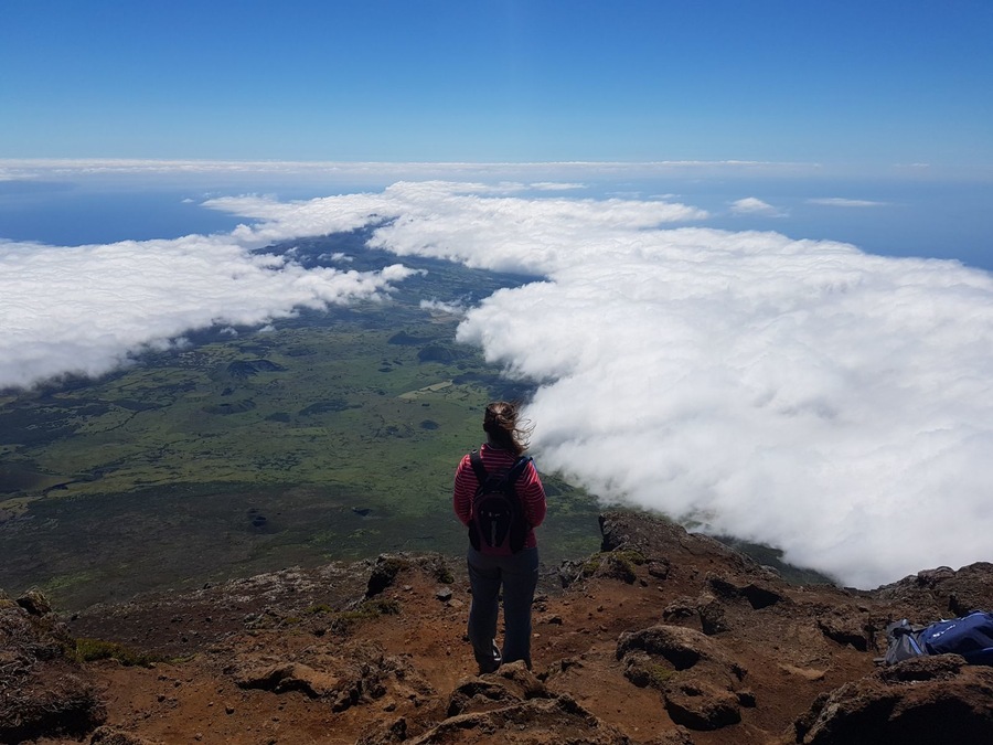 Hiking through hardened lava flow to reach the peak of the volcano. Feeling the warmth from the volcano and getting views like you're on top of the world!