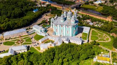 city panoramic landscape in summer with a temple on a hill filmed from a drone
