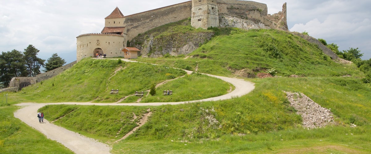 Rasnov Fortress showing chateau or palace as well as a small group of people