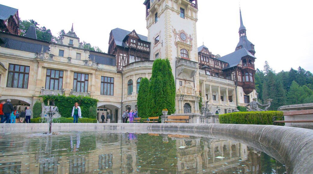 Peles Castle featuring chateau or palace, a fountain and heritage architecture